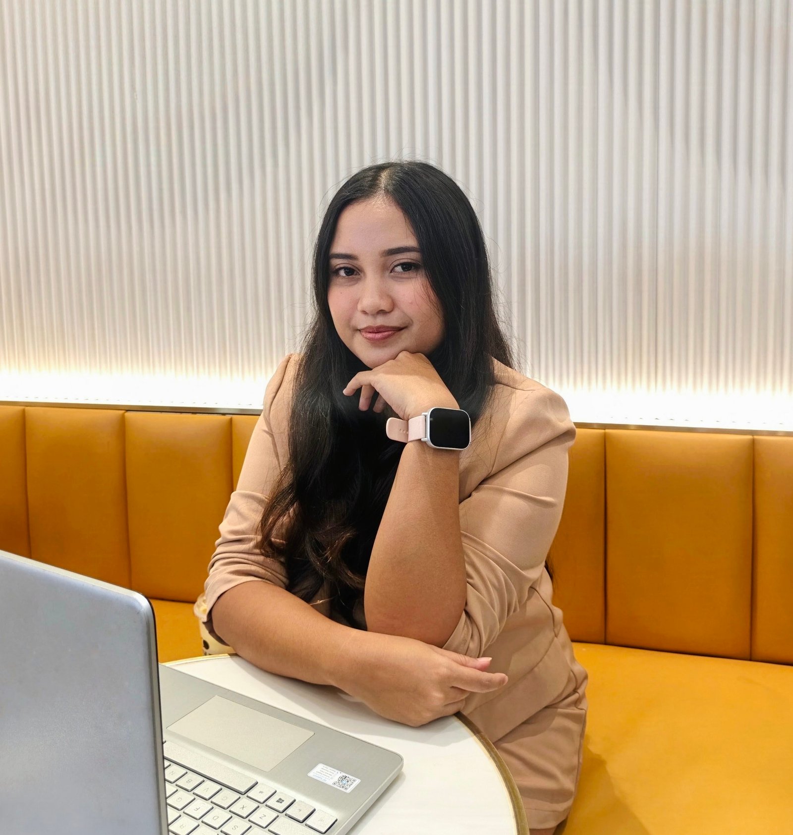 Andrea Baquerfo, Talent Acquisition Recruiter, seated at a desk with a laptop